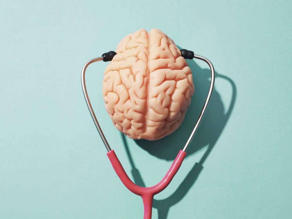 تصویر گرافیکی مغز انسان و گوشی پزشکی